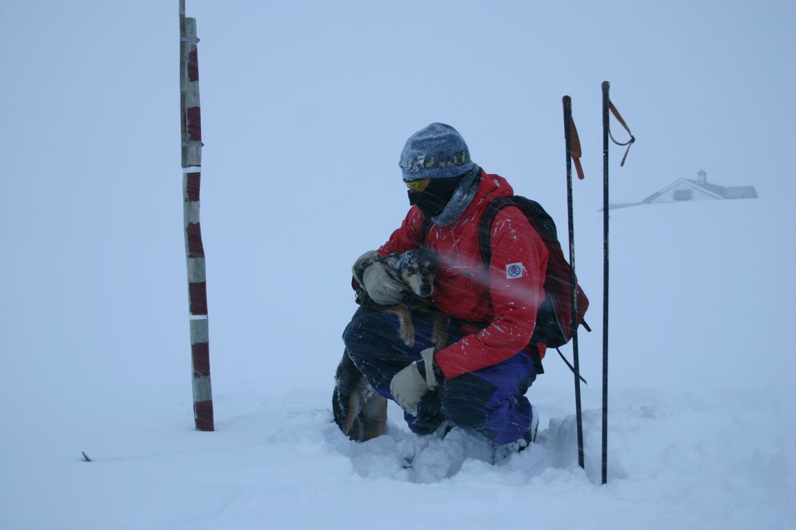 Torstein measuring snow at his family's cabin.